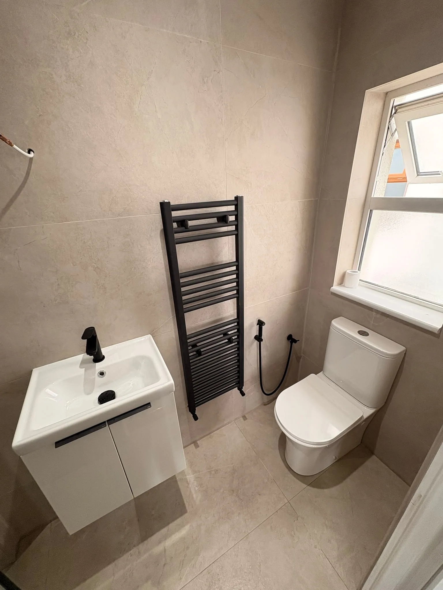 Compact bathroom renovation with vanity and towel radiator in Sligo