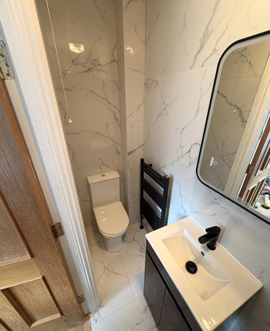 Marble effect bathroom renovation with black fixtures in Sligo