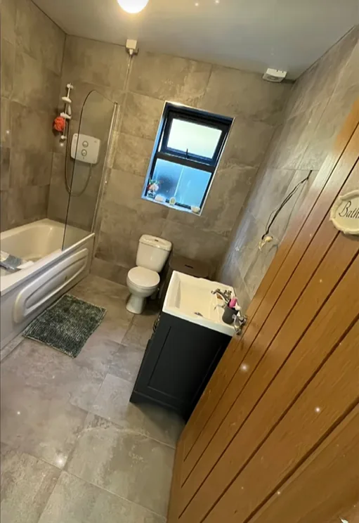 Grey tiled bathroom renovation completed by LMN Plumbing in Sligo